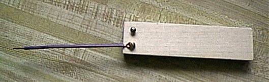 Wire attached
	to block of wood